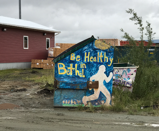"Be Healthy in Bethel" public artwork on a dumpster in Bethel, Alaska