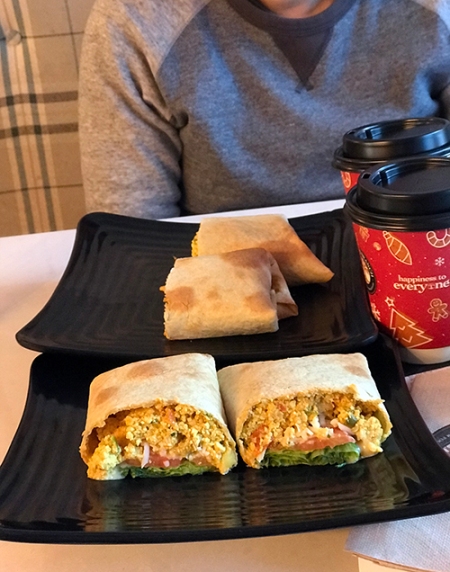 Straight-on shot of a wrap filled with tofu scramble, tomato, and lettuce.